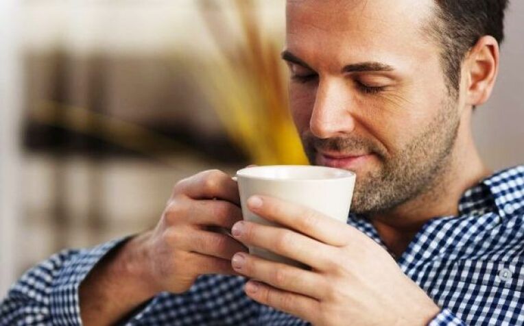 A man drinks a drink made from willow herb tea to increase his potency